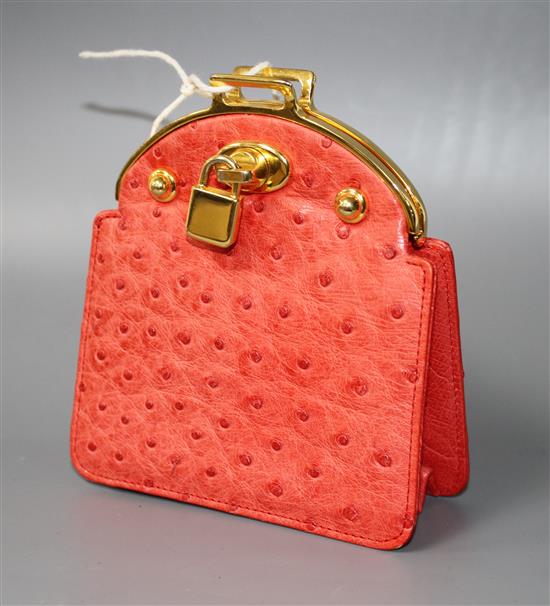 An Asprey red ostrich skin clutch purse, with gilt metal mount and padlock clasp, width 11cm height 12.5cm